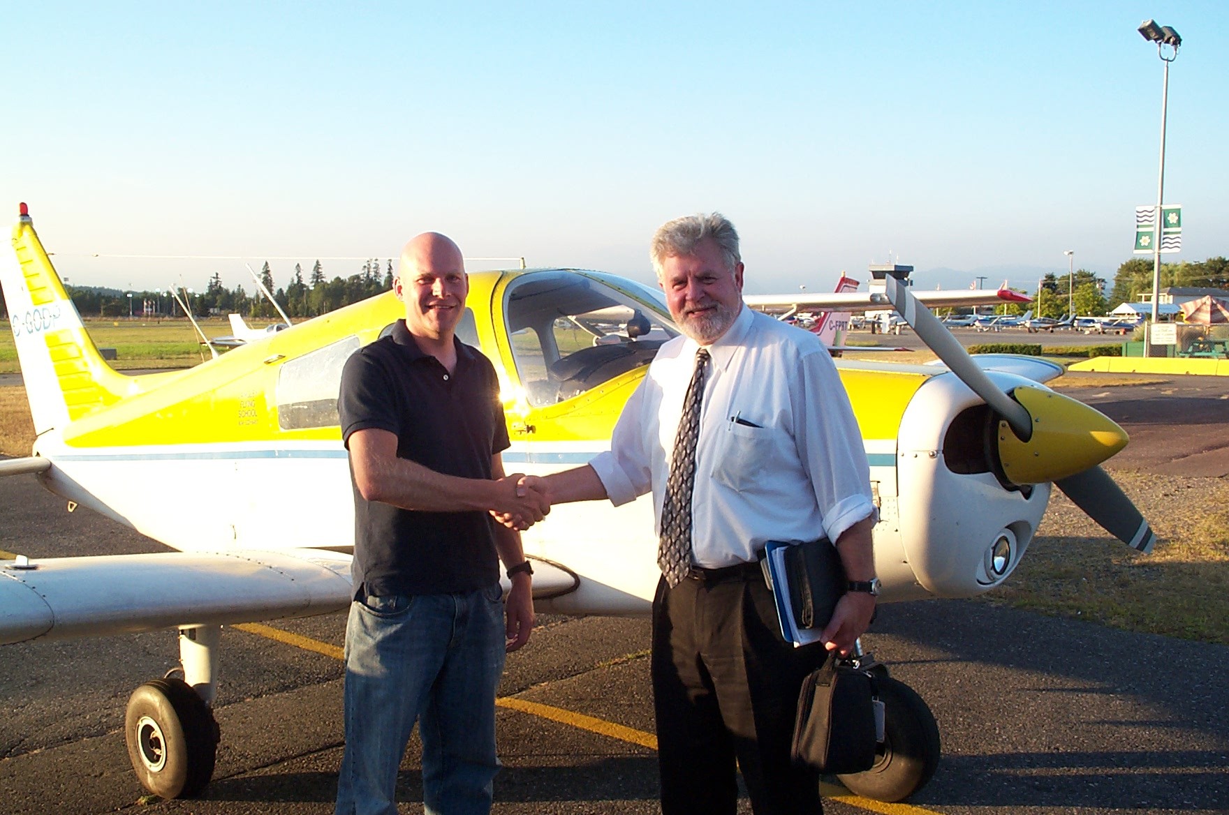 Carl Tingstad receives congratulations from Pilot Examiner Paul Harris following the successful completion of Carl's Commercial Pilot Flight Test on .  Langley Flying School.