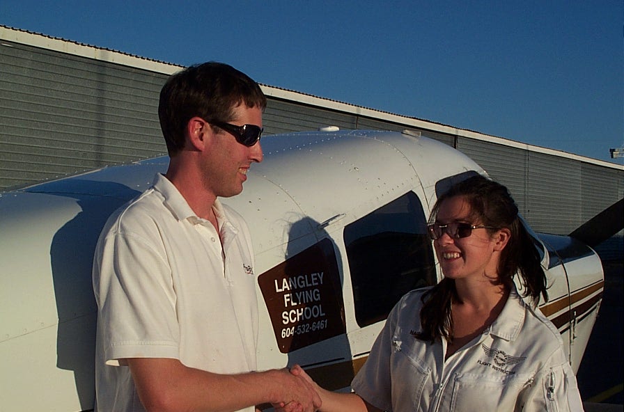 Dean Bicknell is congratulated by Flight Instructor Naomi Jones after the completion of his First Solo Flight.  Langley Flying School.