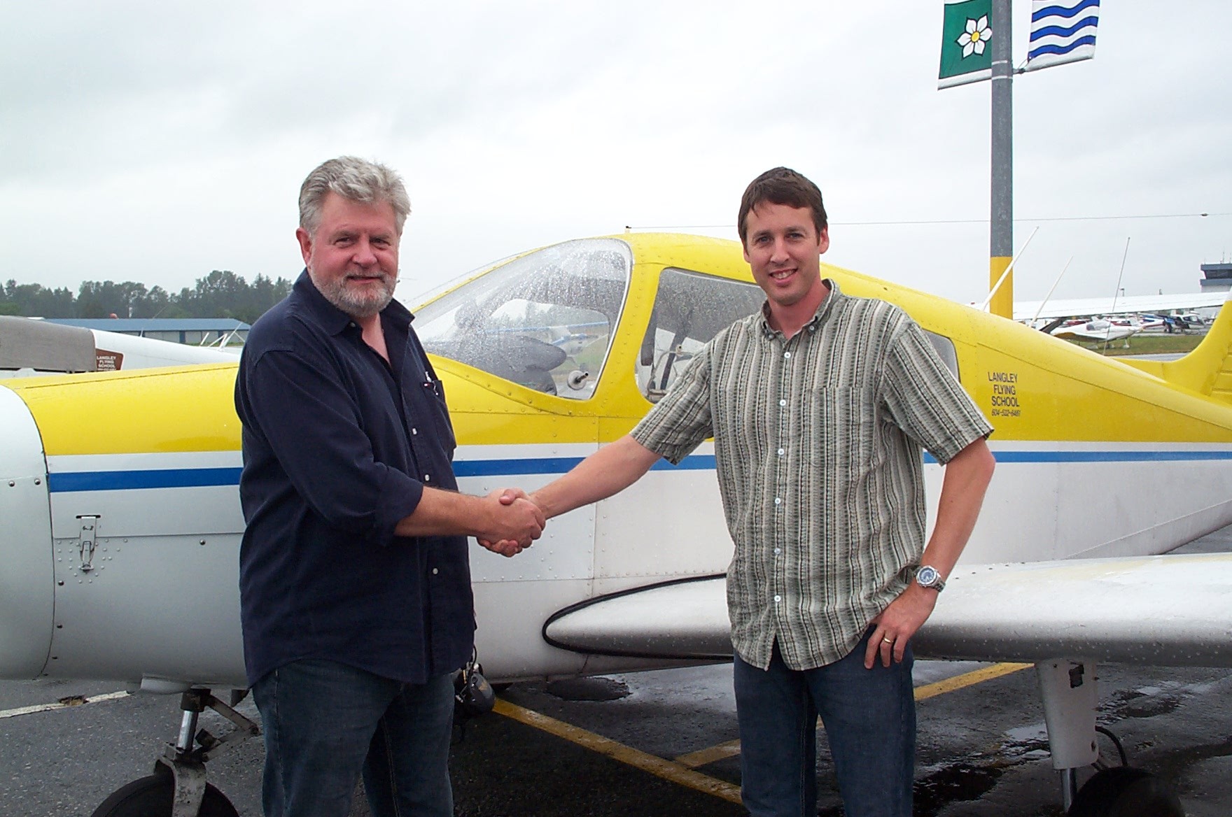 Dean Bicknell receives congratulations from Pilot Examiner Paul Harris after the successful completion of Dean Private Pilot Flight Test.  Langley Flying School.