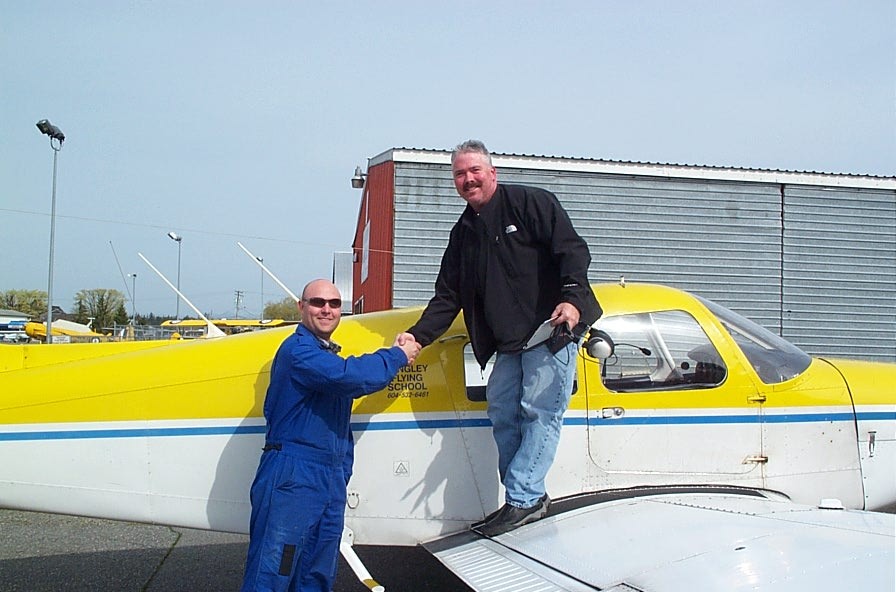 Drew Keeper receives congratulations from his Flight Instructor, Rod Giesbrecht, after completing his First Solo Flight in Cherokee GODP on March 27, 2010.