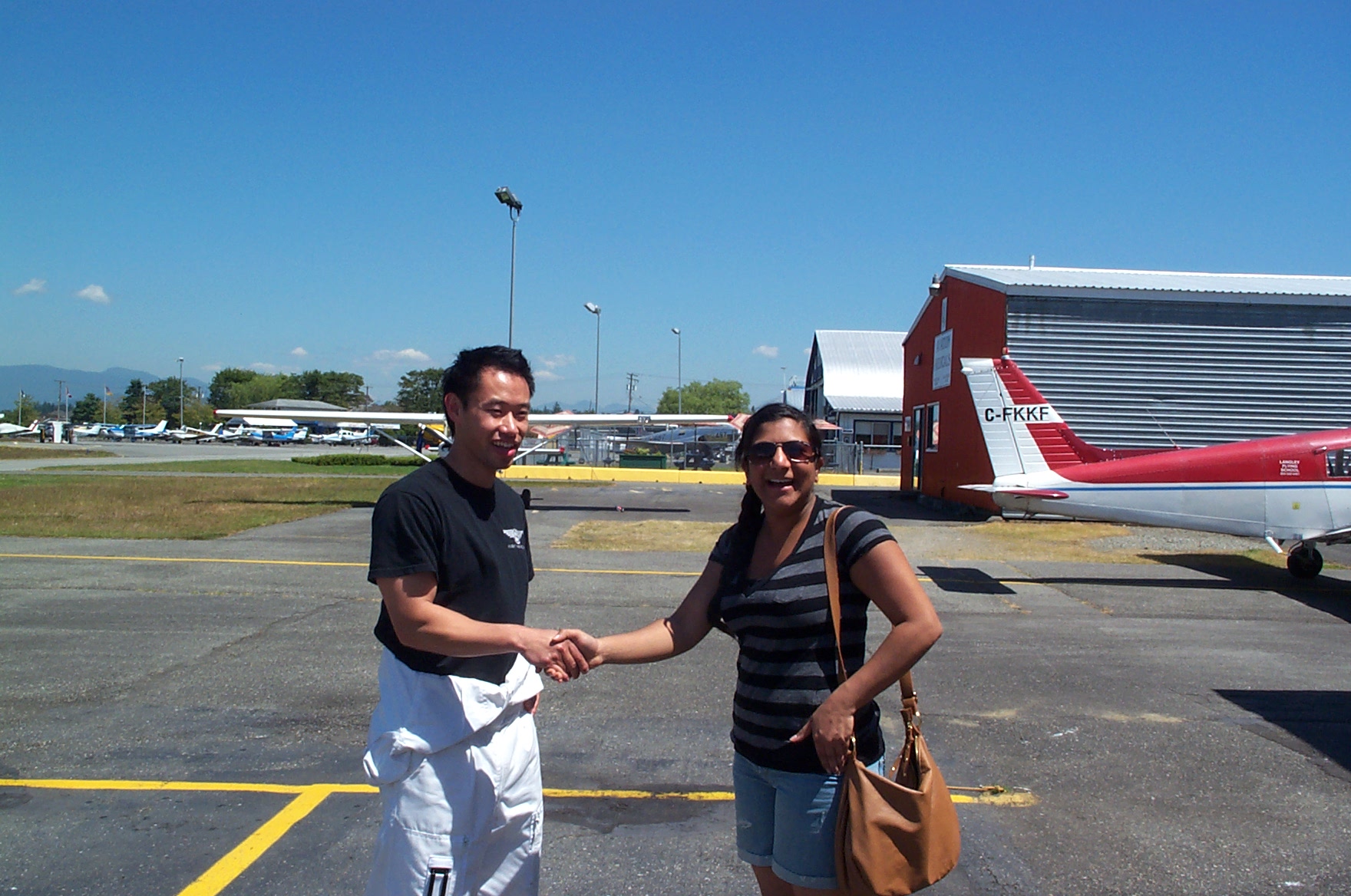Esther Karunakar receives congratulations from her Flight Instructor Nam Hoai Vu after the completion of Esther's First Solo Flight on July 6, 2010. Langley Flying School.