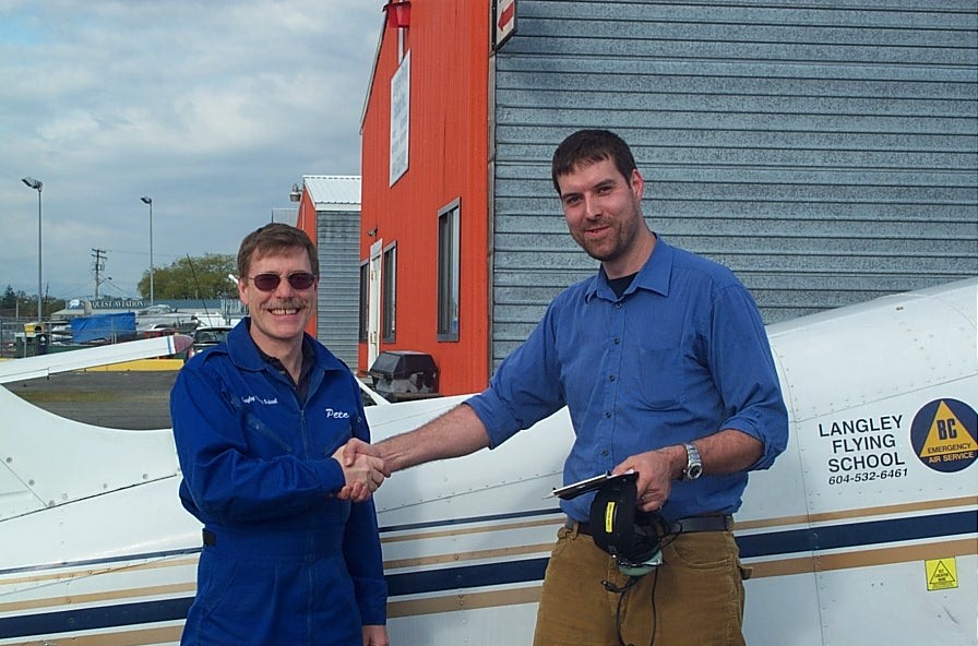 Milan Veverka receives contratulations from Flight Instructor Peter Waddington after completing his First Solo Flight on May 8, 2008.  Langley Flying School.