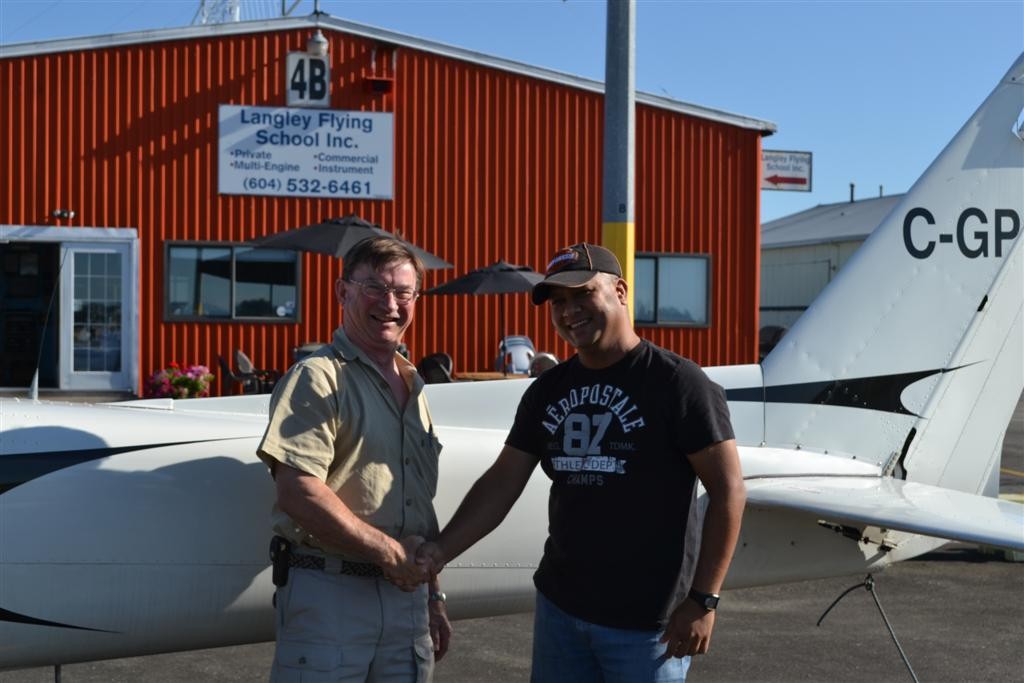 Commercial Pilot Mohit Agnihotri receives congratulations from Pilot Examiner John Laing following the successful completion of his qualifying flight test on August 17, 2011. Langley Flying School.