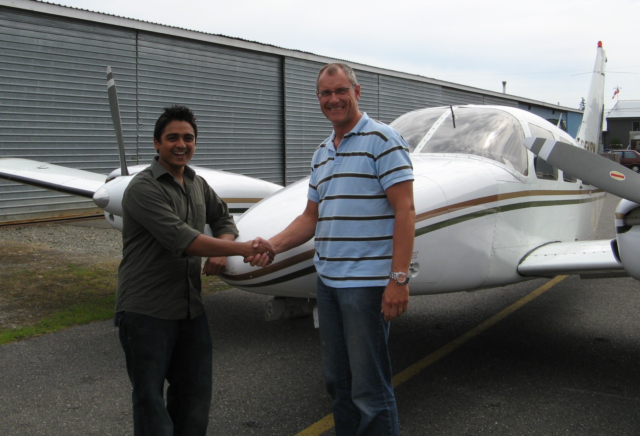 Commercial Pilot Nikhil Dongare with Pilot Examiner Matt Edwards after the successful completion of his Group 1 (Multi-engine) Instrument Rating on August 12, 2008.  Langley Flying School.