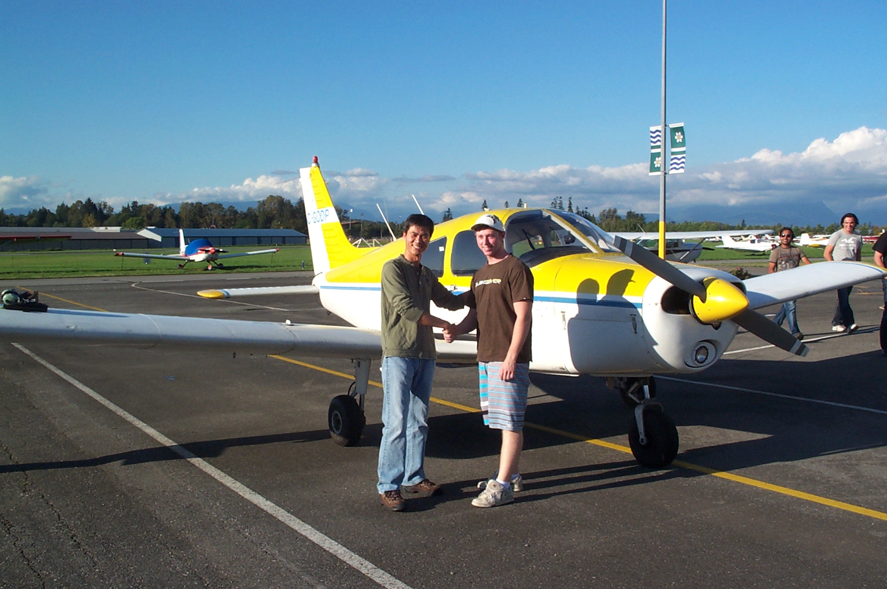 Sheldon Hemmingway is congratulated by Flight Instructor Hoowan Nam after the completion of Sheldon's First Solo Flight in Cherokee GODP on September 28, 2010. Langley Flying School.