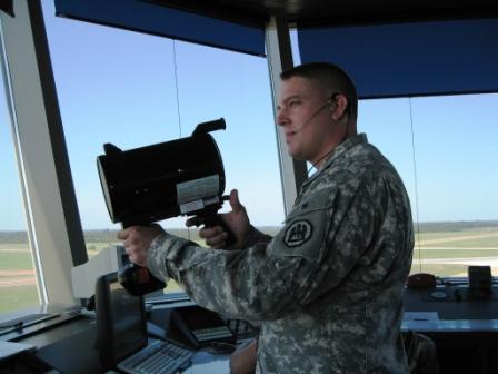 Military air traffic controller with light gun.  Courtesy Wikipedia.  Langley Flying School.